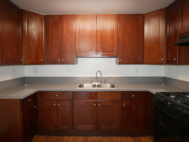 Kitchen with Wood Style Cabinets and Sink | Bella Vista