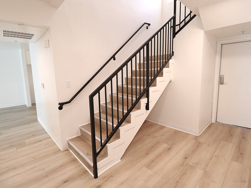 Stairwell with Wood Style Floor and Hand Rail | Bella Vista