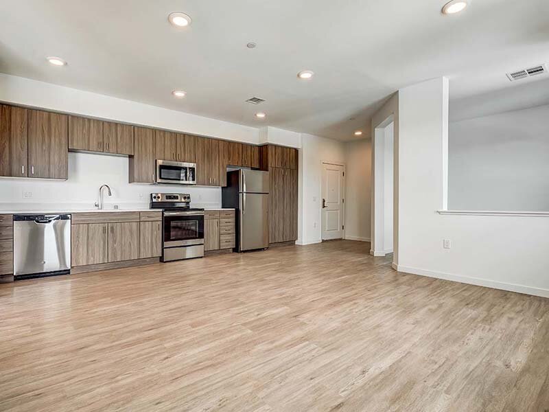 Open View of Kitchen with Wood Styled Floors and Ceiling Lights | Ageno Affordable