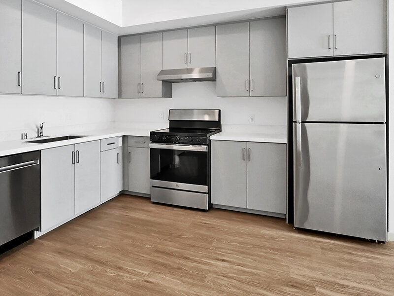 Apartment Kitchen Area with Appliances and Wood Style Flooring | Mission Gateway