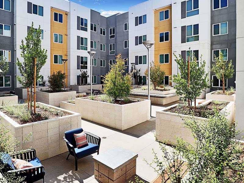 Exterior View of Apartment Complex with Foliage | Mission Gateway