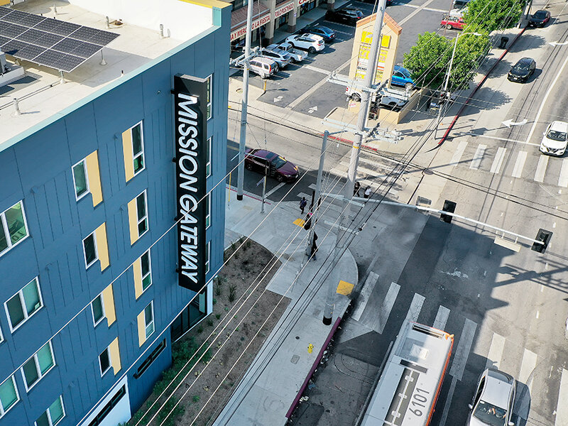 Apartment Complex with Sign and Cars | Mission Gateway