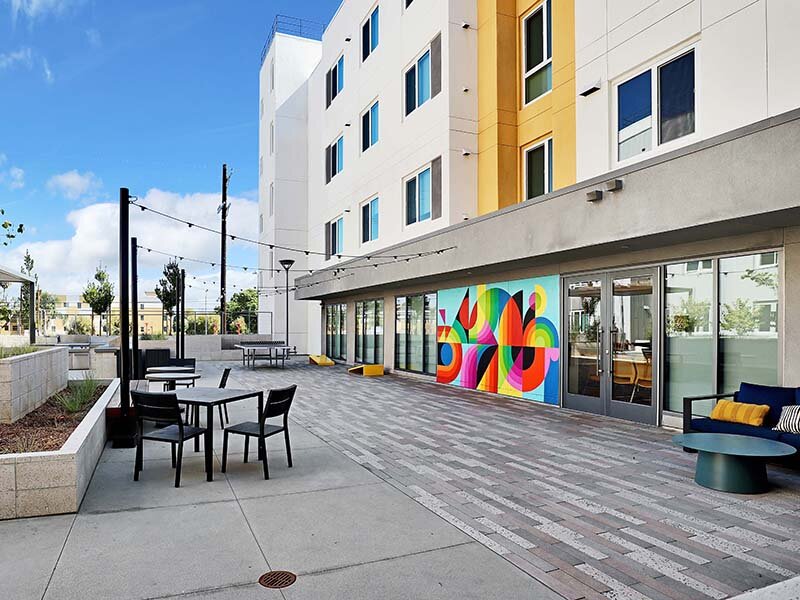 Exterior View of Apartment Seating and Wall Art | Mission Gateway