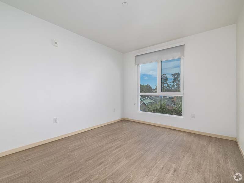Apartment Bedroom with Window and Wood Style Floors | Mission Gateway