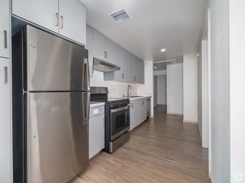 Apartment Kitchen with Appliances and Wood Style Flooring | Mission Gateway