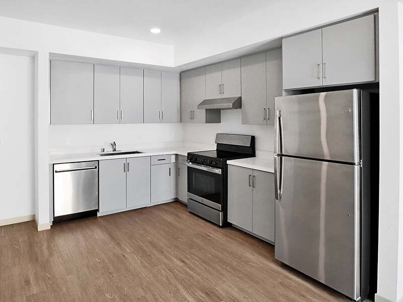 Apartment Kitchen with Wood Style Flooring and Appliances | Mission Gateway