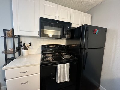 Kitchen with Black Appliances | The Reserve at Water Tower Village Apartments