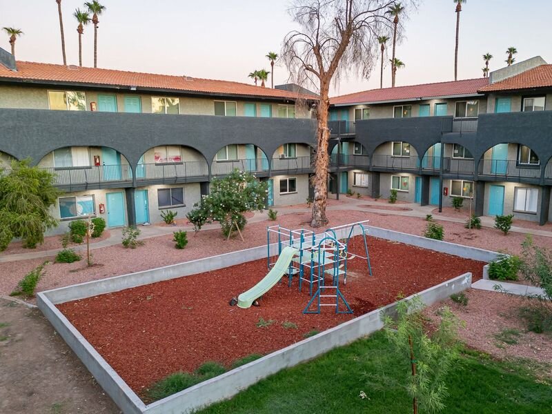 Playground & Apartment Exterior | Buenas on Indian School