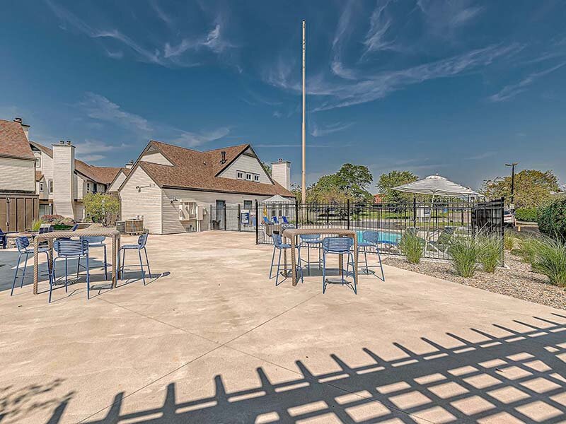Apartment Complex with View of Swimming Pool and Outdoor Patio Seating | Avia Lofts at Founders Road