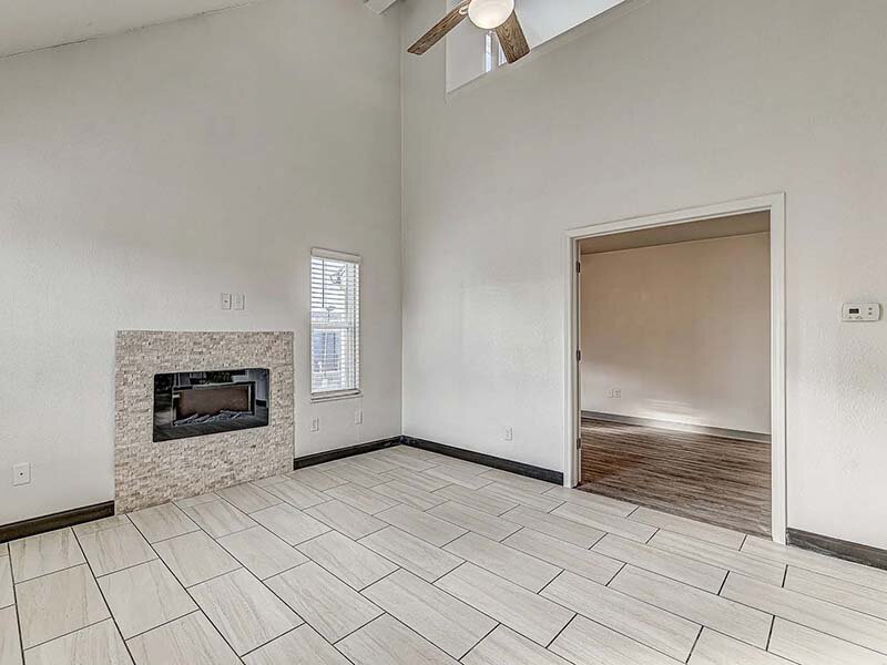 Living Room with Ceiling Fan and Light with Fireplace | Avia Lofts at Founders Road