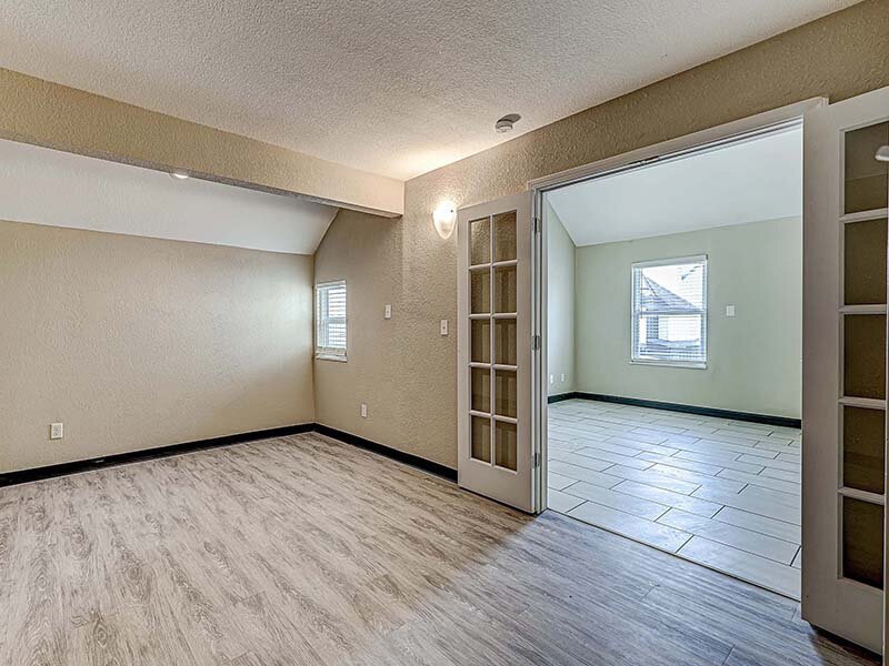 Apartment Bedroom with Window and Wood Style Flooring | Avia Lofts at Founders Road
