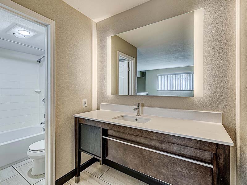 Apartment Bathroom with Sink and Wood Style Cabinets | Avia Lofts at Founders Road