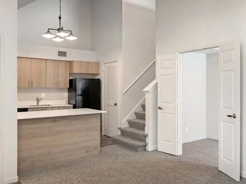 Kitchen with View of Staircase and Carpeted Flooring | Avia at 110th St