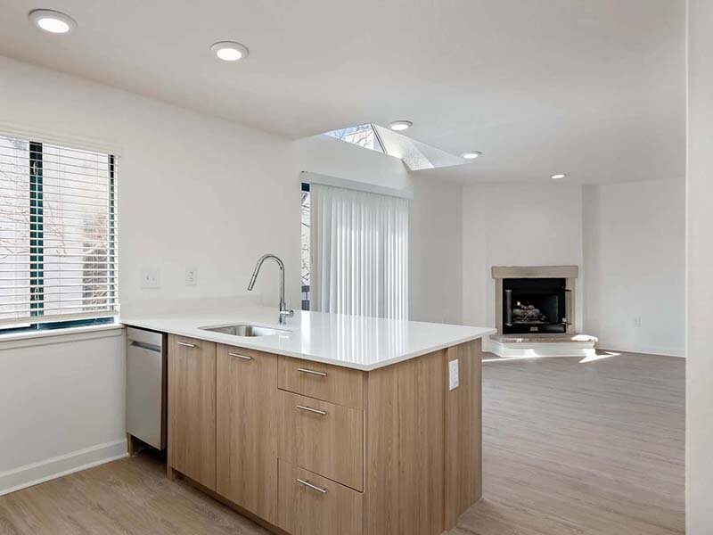 Kitchen with View of Patio and Fireplace in Living Room | Avia on College Boulevard