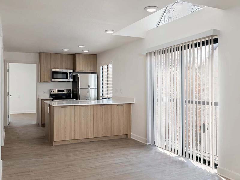 Kitchen with View of Patio and Wood Style Flooring | Avia on College Boulevard