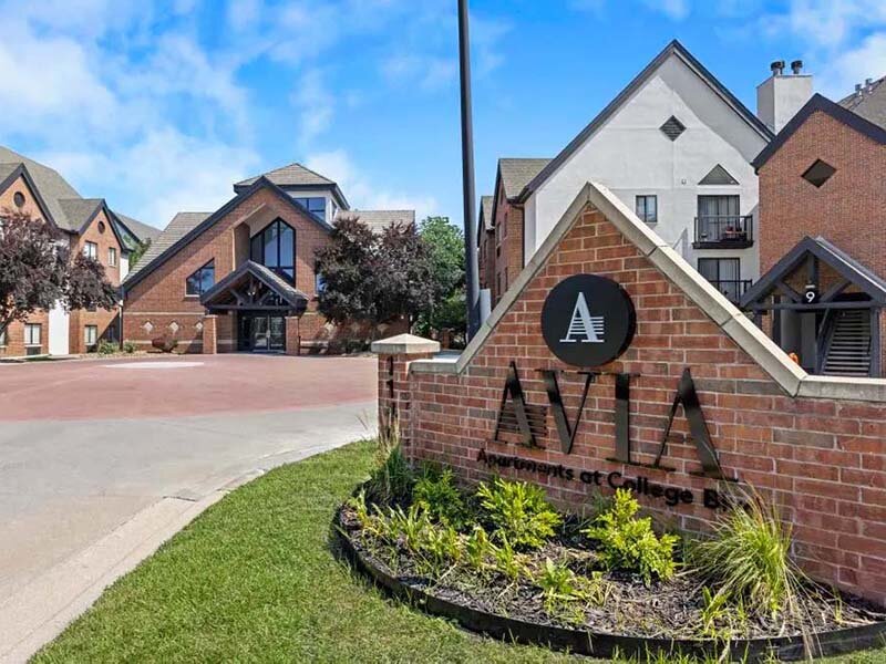 Exterior View of Apartment Property with Monument Sign | Avia on College Boulevard
