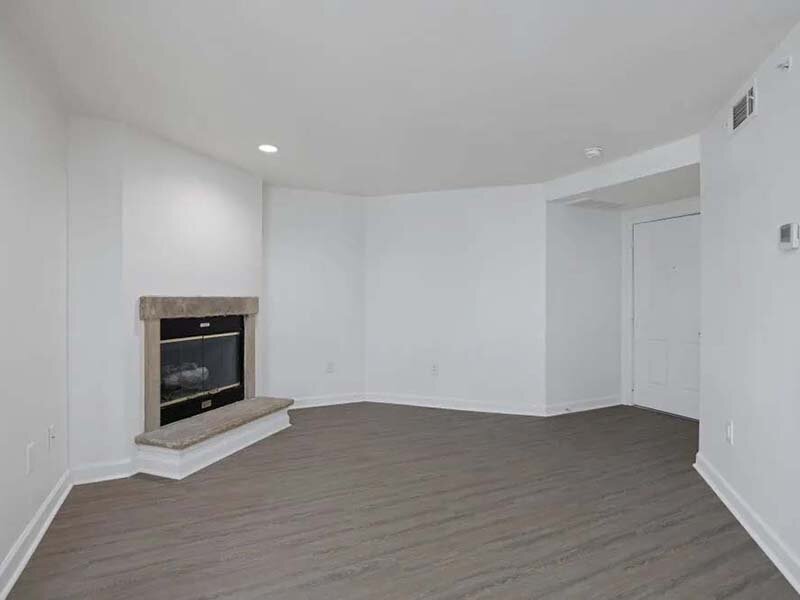 Living Room Fireplace with Wood Style Flooring | Avia on College Boulevard