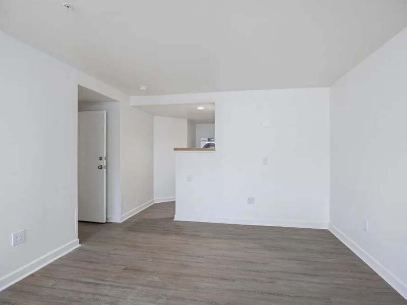 Living Room with View of Hallway and Wood Style Flooring | Avia on College Boulevard