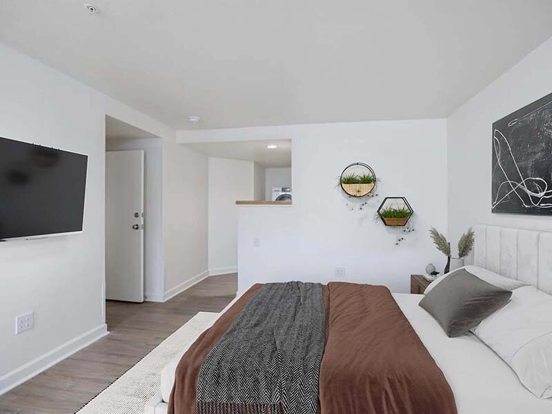 Bedroom with Wall Art and Wood Style Flooring | Avia on College Boulevard