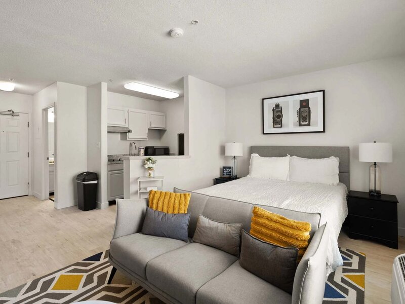 Apartment Bedroom with Wall Art and Ceiling Light | Avia Lofts at North Shore