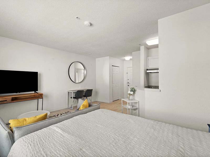 Bedroom with Wall Clock and Television | Avia Lofts at North Shore