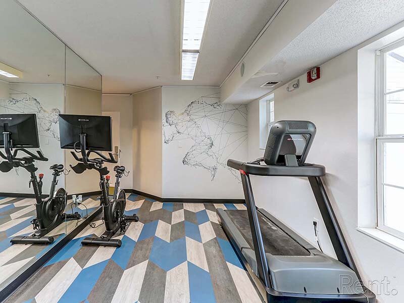 Community Fitness Center with Ceiling Lights | Avia Lofts at North Shore