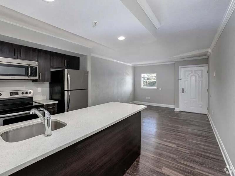 Kitchen with Apartment Entrance and Wood Style Flooring | Avia At Reedy Creek