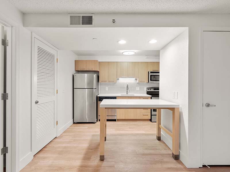 Apartment Kitchen with Table and Ceiling Lights | Avia Lofts on Parkway