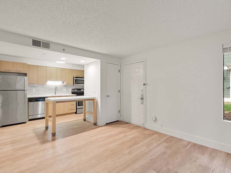 Apartment Interior Entrance with Views of Kitchen and Wood Style Flooring | Avia Lofts on Parkway