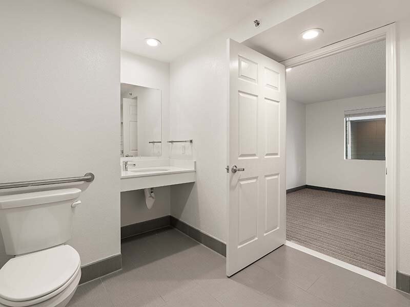 Apartment Bathroom with Views of Hallway and Open Door | Avia Lofts on Parkway