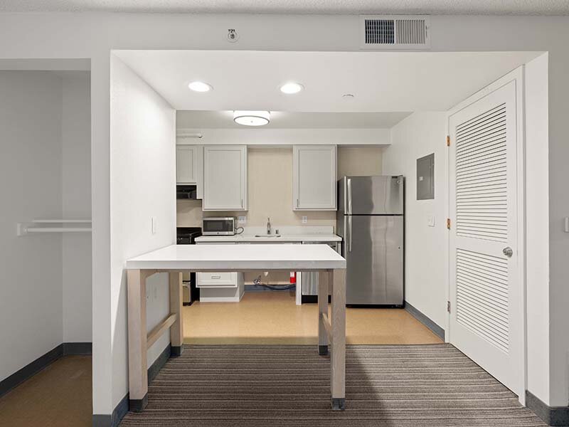 Apartment Kitchen with Wood Style Flooring and Table | Avia Lofts on Parkway