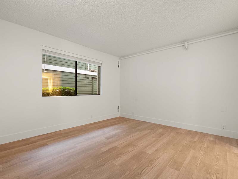Apartment Bedroom with Window and Wood Styled Flooring | Avia Lofts on Parkway