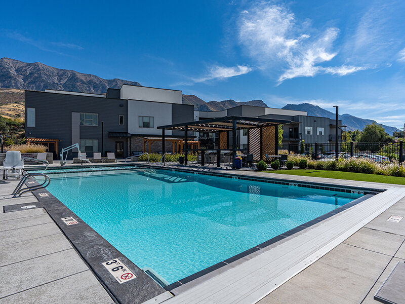 Pool and Building Exterior | Flats at Riverwoods