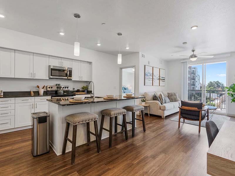 Kitchen with Bar Stools and View of Living Room | City View St. George