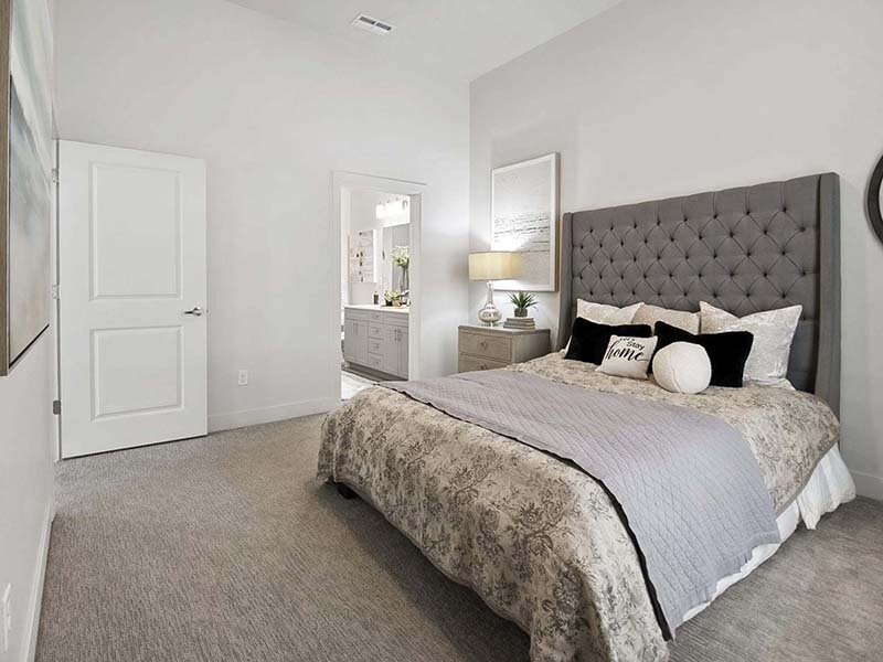 Bedroom with Carpeted Floors and View of Bathroom | 200 City View