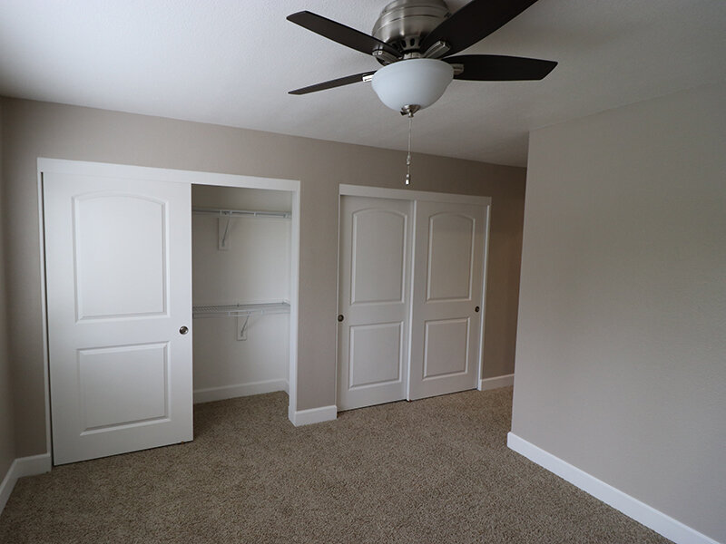 Apartment Bedroom with Ceiling Fan and Carpeted Flooring | Pentagon