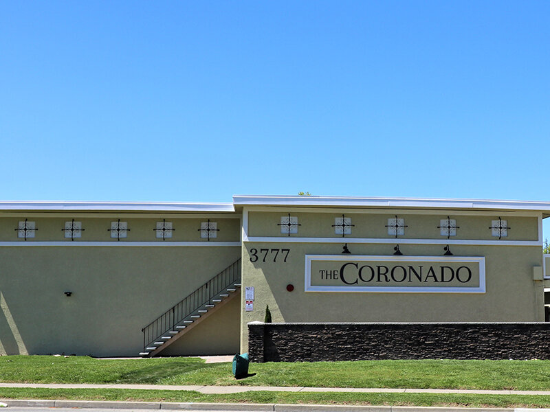 Outdoor View of Apartment Property with Monument Sign | Coronado