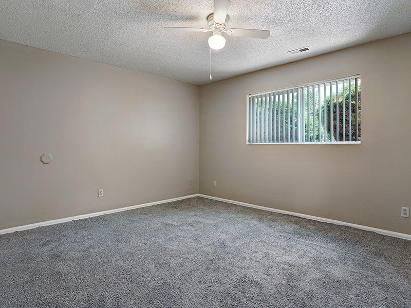 Bedroom with Ceiling Fan and Carpeted Floors | Sienna Place