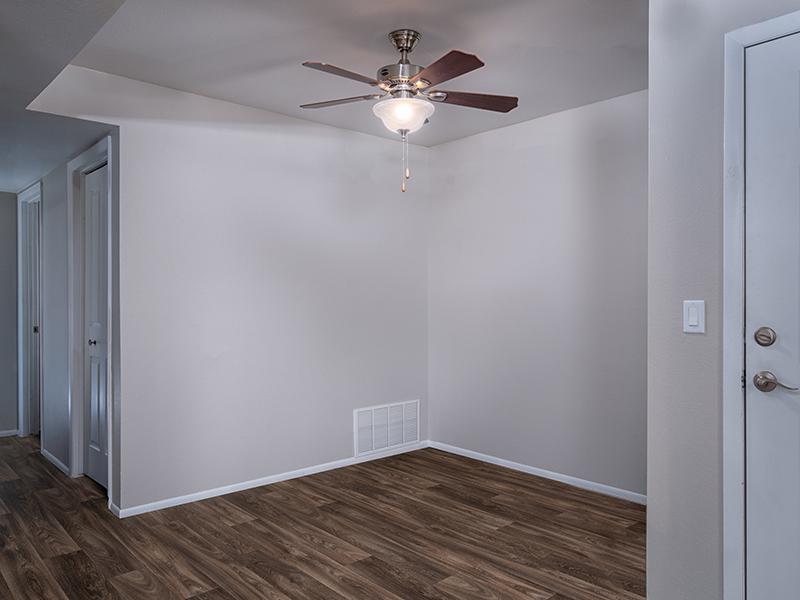 Apartments for Rent in Midvale, UT - Creekview - Open Concept Dining Area with Wood-Style Flooring and Ceiling Fan.