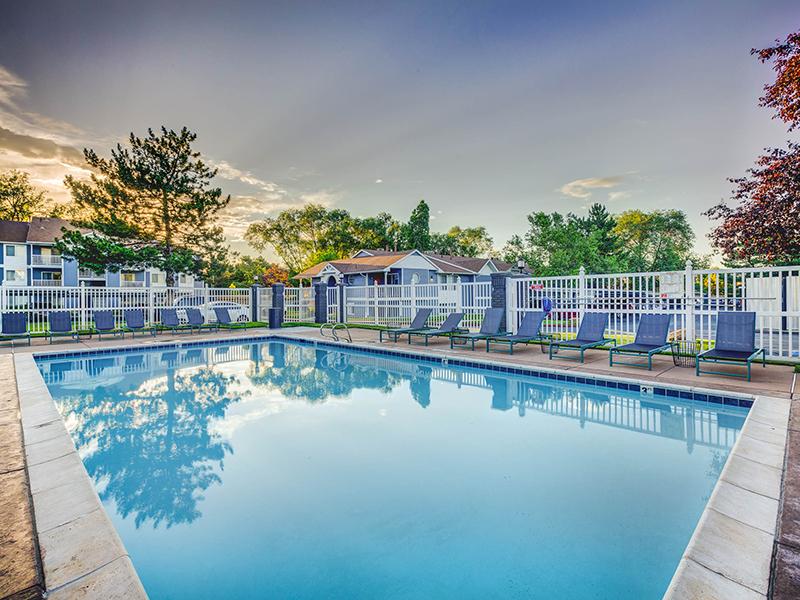 Midvale Apartments - Creekview Apartments - Large Gated Pool Surrounded by Lounge Chairs