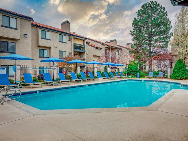 Two-BR Apartments in Cottonwood Heights, UT - Santa Fe at Cottonwood - Sparkling Year Around Pool with Lounge Chairs and Umbrellas.