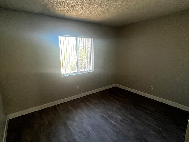 Bedroom with Window and Wood Styled Flooring | Seventeen 805