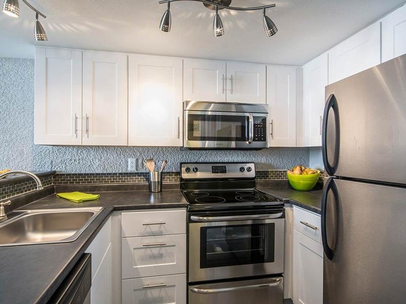 Apartments for Rent in Phoenix AZ - Portola Biltmore - Upgraded Kitchen with White Cabinetry, Dark Grey Countertops, and Stainless Steel Appliances