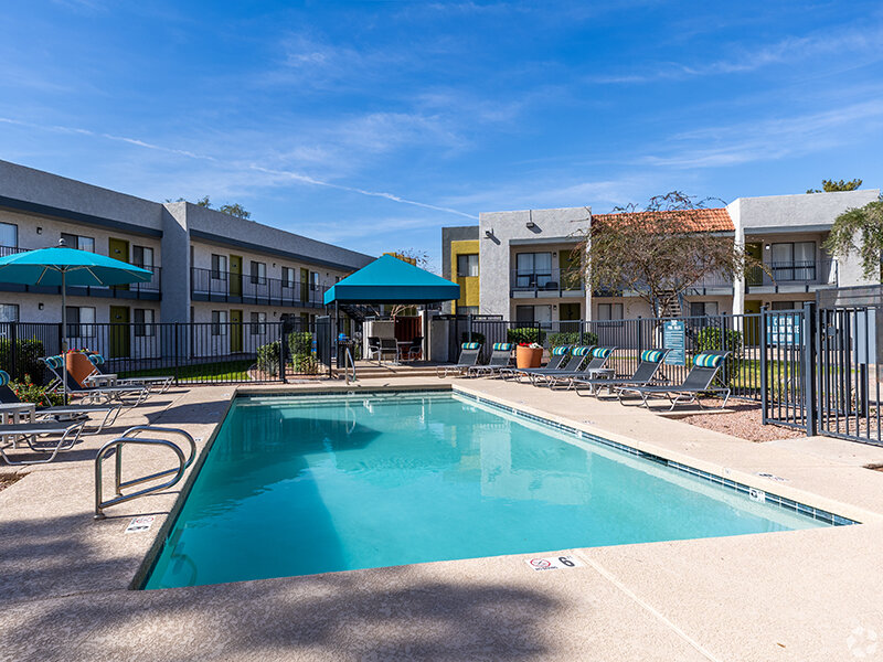 Exterior Pool with Patio Umbrella's and Stone Style Flooring | Emerson Square
