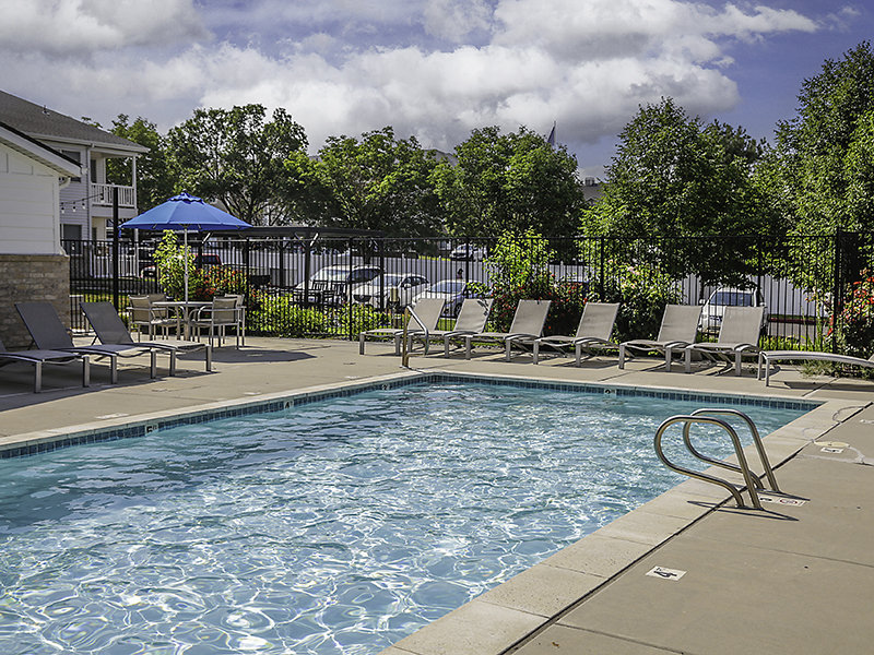 Swimming Pool with Lounge Chairs | Creekside Village Apartment Homes