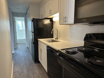 Kitchen with Black Appliances | The Perch on 52nd