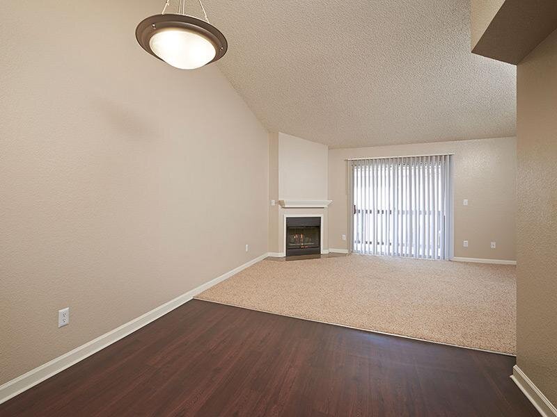 Dining Area and Living Room with Fireplace | Arapahoe Club Apartments in Denver, UT