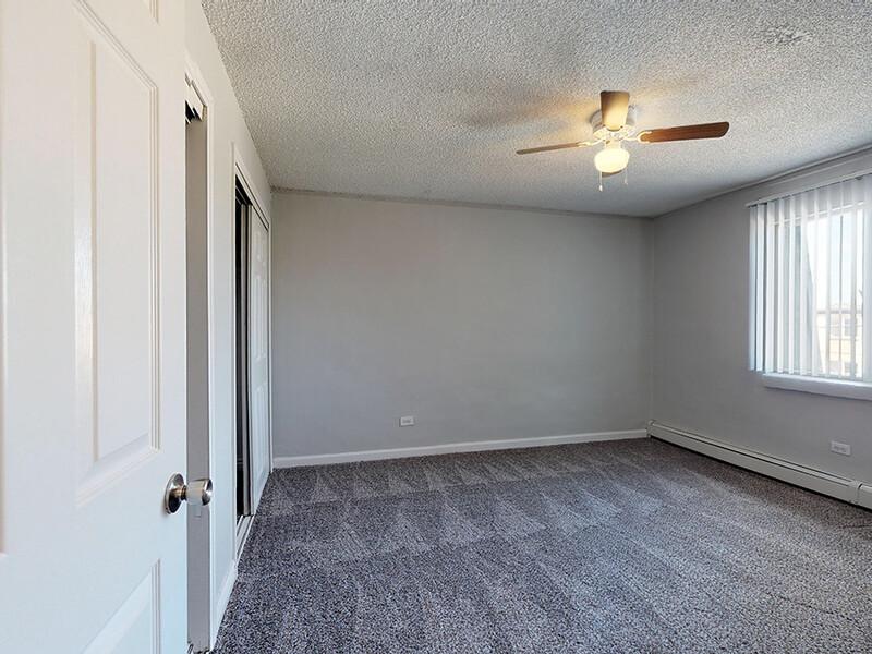 Bedroom with a Ceiling Fan | Montego Flats Apartments in Aurora, CO