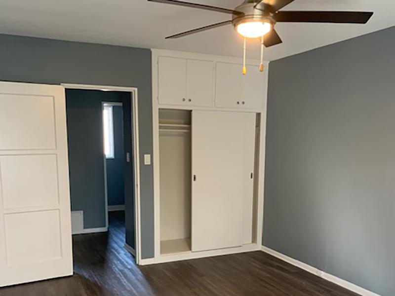 Two-Bedroom Apartments in Los Angeles, CA - Verdugo Mesa - Bedroom with Sliding Closet Door, Ceiling Fan, and Wood-Style Floors
