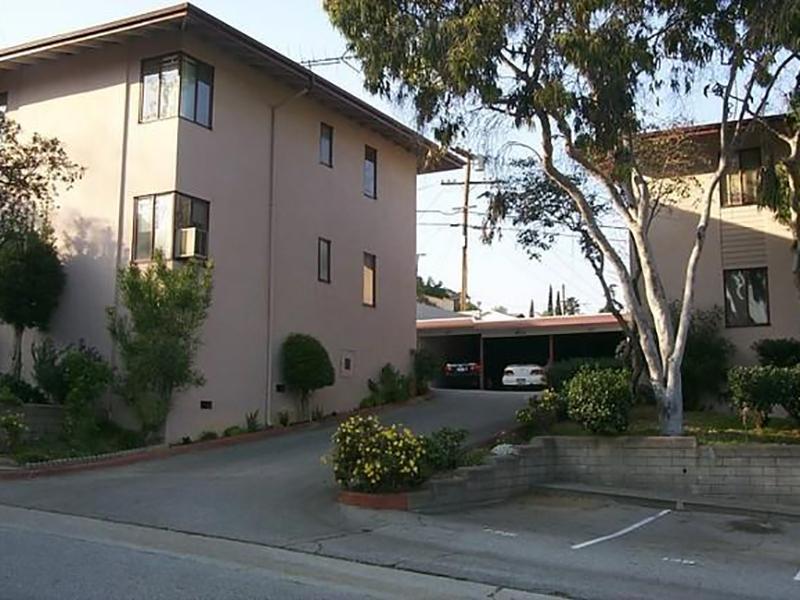 Apartments in Los Angeles for Rent - Building - Building with Covered Parking, View of Apartment Complex, and Manicured Bushes
